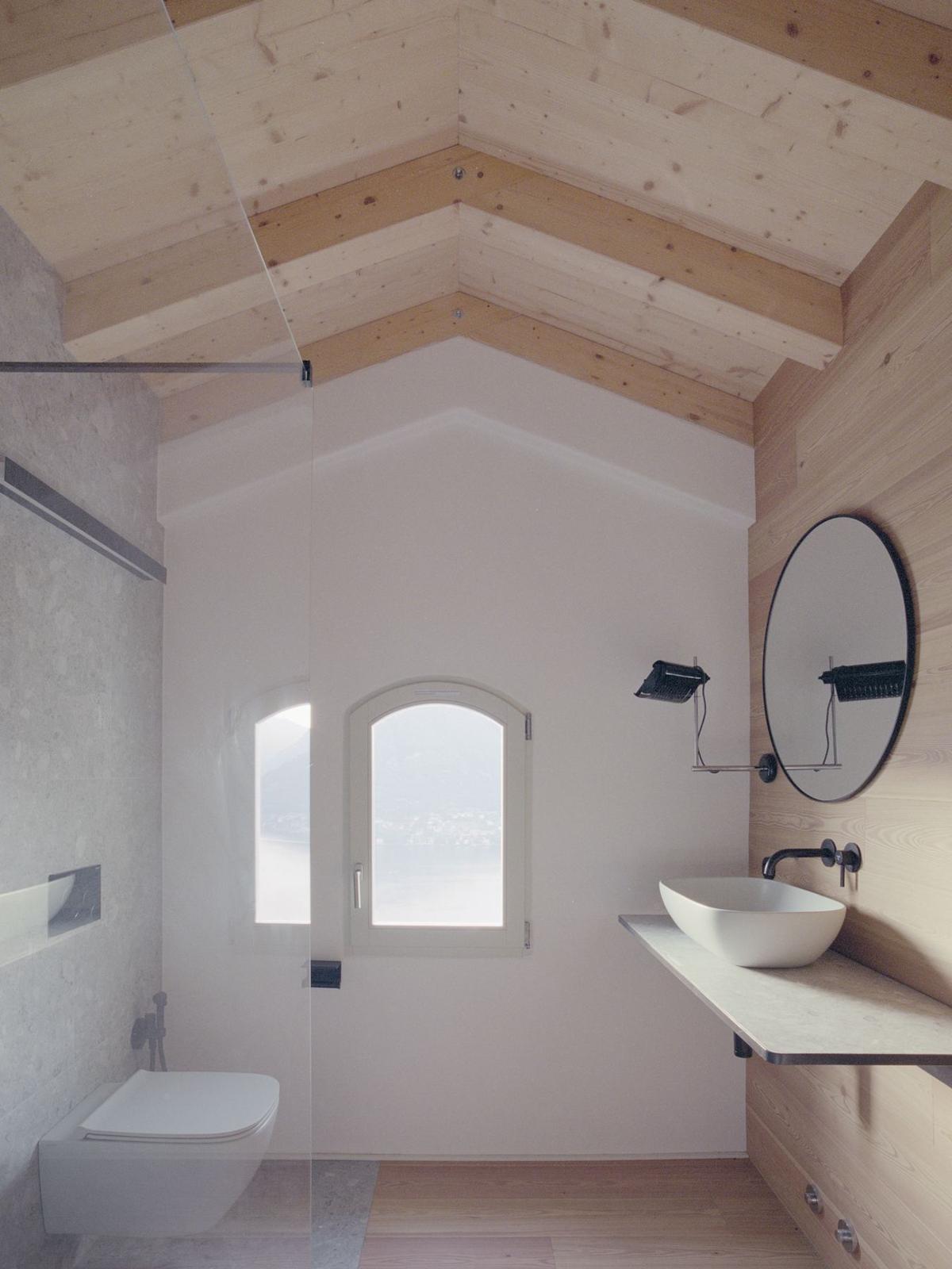 Bathroom with timber roof and lake view window
