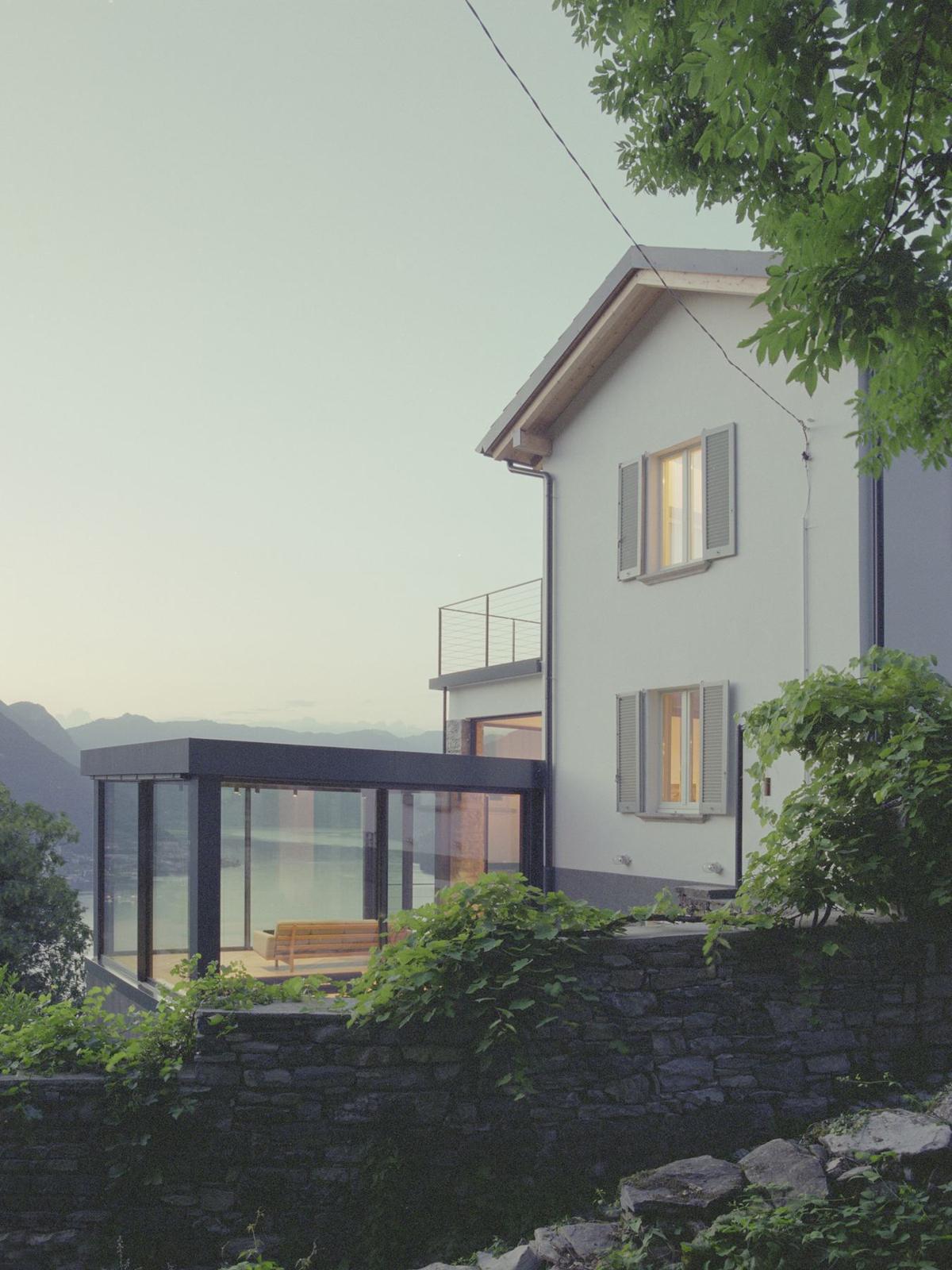 The villa with its glass pavilion above Lake Como at dusk